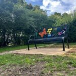 Butterflies and bees bench in blue sky